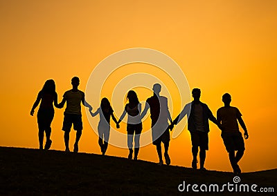 Group of People Holding Hands in Back lit Stock Photo