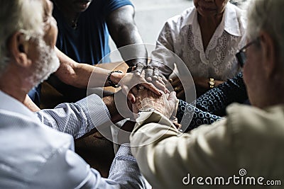 Group of people holding hands praying worship believe Stock Photo