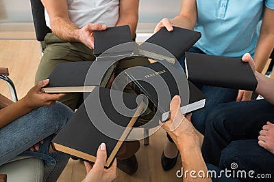 Group of people holding holy bible Stock Photo