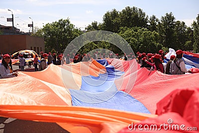 Group of people holding a large flag of Armenia during a parade Editorial Stock Photo