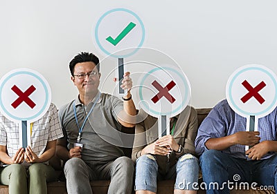 Group of people holding true & false icons Stock Photo