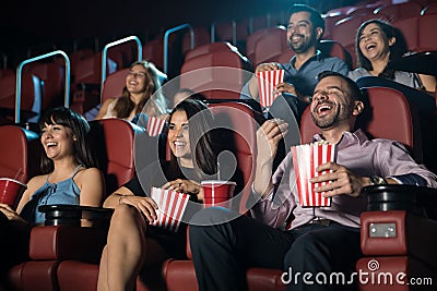 Group of people laughing at the movie theater Stock Photo