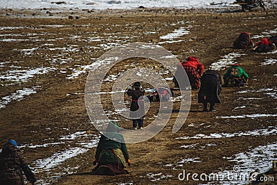 Group of people paying homage to Mount Kailash and snow on the land in Taqin County, Tibet, China Editorial Stock Photo