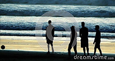 Group of People playing Football on Cabourg Beach at Sunset, Normandy Stock Photo