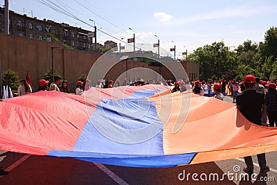 Group of people proudly displaying the Armenian flag during a celebratory parade Editorial Stock Photo
