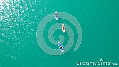 A group of people ride sup surfing in the lake. Stock Photo