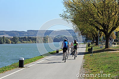 Group of people riding bicycles along the Danube river. Lower Austria. Editorial Stock Photo