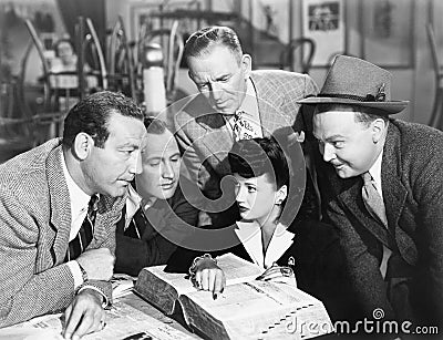 Group of people searching in a big book Stock Photo