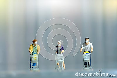 Group of people shopping at supermarket with maintain their physical distance. Miniature people figurines toys conceptual Stock Photo