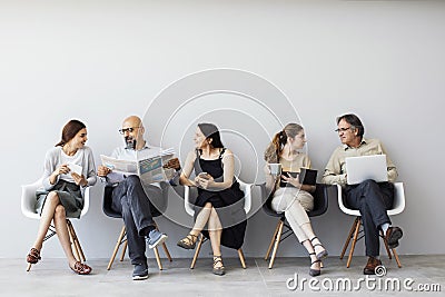 Group of people sitting on chairs Stock Photo