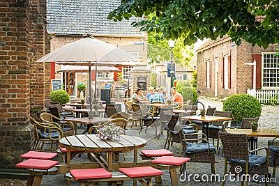 Group of people sitting in openair cafe in a street of Bronkhorst city, Gelderland, Netherlands Editorial Stock Photo