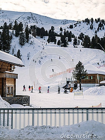Group of people skiing at a ski resort slope facility Stock Photo