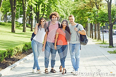 Group of people smiling on a city street in summer. Stock Photo