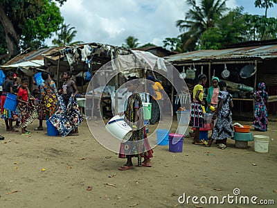 Group of people strolling through a charming village in Mocimboa da Praia, Mozambique Editorial Stock Photo
