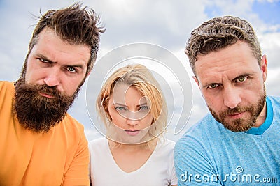 Group people suspect you. Suspicious look. Threesome suspiciously look down. Woman and men look confident sky background Stock Photo