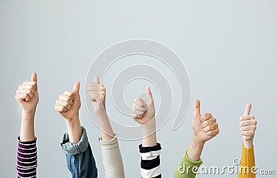 Group of people thumps up on grey background Stock Photo