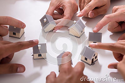 Group Of People Touching Miniature House Stock Photo