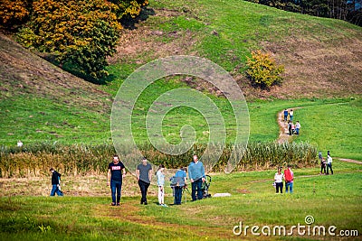 Group of people walking near Kernave hills Editorial Stock Photo