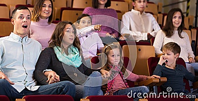 Group of people watching exciting movie Stock Photo