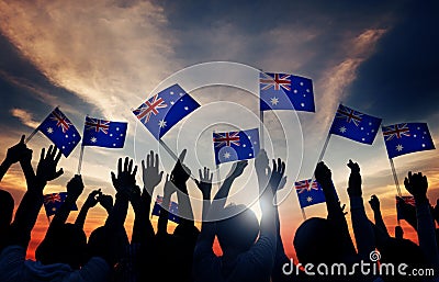 Group of People Waving Australian Flags in Back Lit Stock Photo