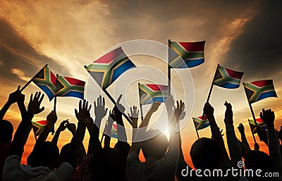 Group of People Waving South African Flags in Back Lit Stock Photo