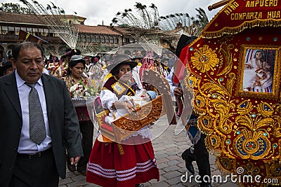 A group of people wearing traditional clothes and masks during the Huaylia on Christmas day at the Plaza de Armas square in the ci Editorial Stock Photo