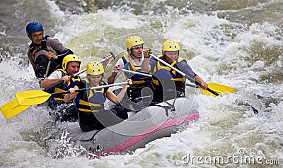 Group of people whitewater rafting Stock Photo