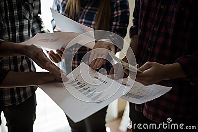 A group of people working man and woman in the plaid shirt Talking/consulting/idea about doing business/Profit Business Benefits. Stock Photo