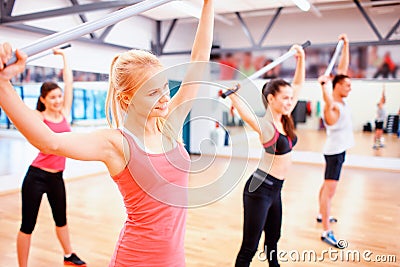 Group of people working out with barbells in gym Stock Photo