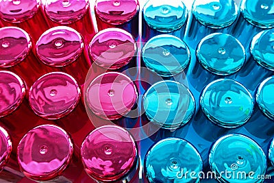 Group of perfume bottles colourful blue and pink top view . Bottle Caps Stock Photo