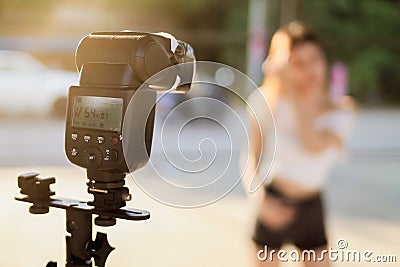 A group of photographers is recording the model using a separate flash to illuminate the subject and add dimensionality. A Stock Photo
