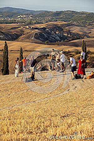 Group of photographers waiting for a golden hour to photograph iconic summer landscape of Toscana. Editorial Stock Photo