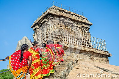 Group of pilgrim women dressed in colorful red and yellow sarees on the way to Olakkannesvara Temple, Mahabalipuram, Editorial Stock Photo
