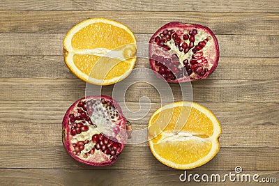 Group pomegranate and orange fruit lay on wooden table Stock Photo