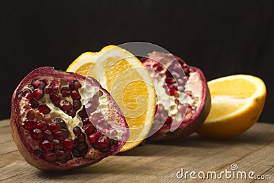 Group pomegranate and orange fruit on wooden table Stock Photo