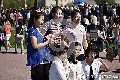 Group portrait of Chinese girls on the celebration of Victory Day in the Russian city Editorial Stock Photo