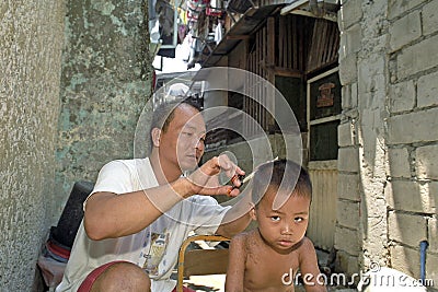 Group portrait Filipino father, the barber, and son Editorial Stock Photo
