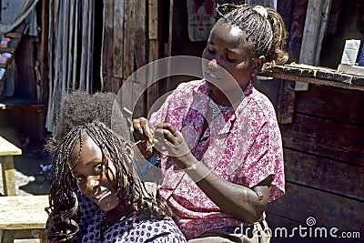 Group portrait of hairdresser and laughing customer Editorial Stock Photo