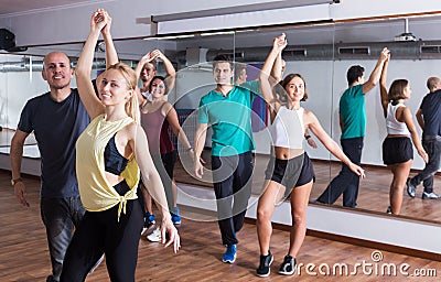Group of positive people dancing bachata together Stock Photo