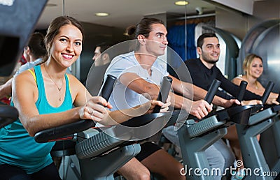 Group positive working out of cycling in fitness club Stock Photo