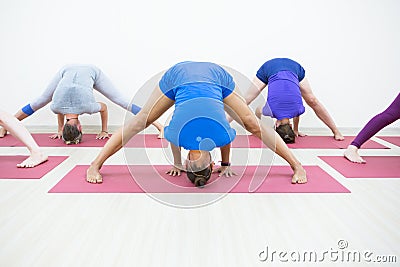 Group of positivel people practicing yoga in gym Stock Photo