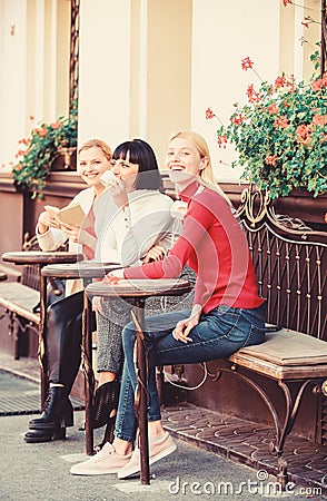 Group pretty women terrace entertain themselves with reading and listening. Coffee cafe. Way to relax and recharge Stock Photo