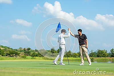 Group Professional Golfer asian man shake hand for friendship after finish put ball on green. Hobby relax in holiday and vacation Stock Photo