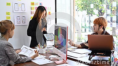 Group of professionals web developers brainstorming and working together for mobile application software design project. Stock Photo