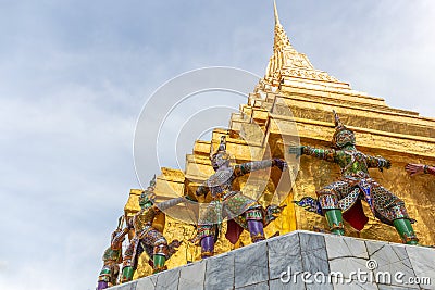 Ramayana demon statue and Golden Pagoda Stock Photo