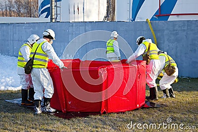 Group of rescuers eliminates consequences of accident, leak of chemical product elimination Stock Photo