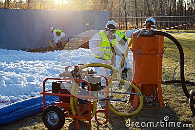 Group of rescuers eliminates consequences of accident, leak of chemical product elimination Stock Photo