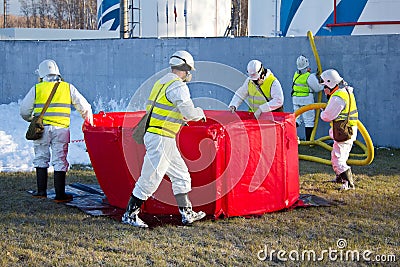 Group of rescuers eliminates consequences of accident, leak of chemical product elimination Stock Photo