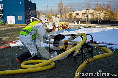 Group of rescuers eliminates consequences of accident, leak of chemical product elimination Editorial Stock Photo