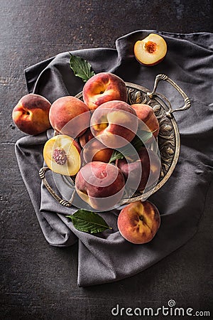 A group a ripe peaches in rustic bowl Stock Photo